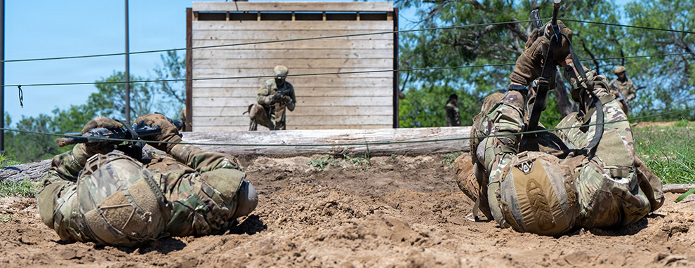Basic Defender Course students train over obstacles